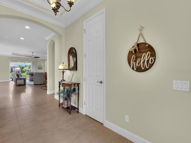 2749 Lambay Ct, Cape Coral, FL 33991 - corridor with arched walkways, ornamental molding, recessed lighting, light tile patterned flooring, and a chandelier
