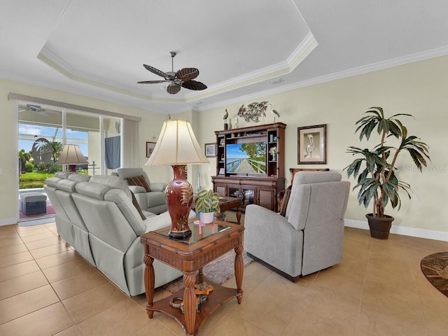2749 Lambay Ct, Cape Coral, FL 33991 - living room featuring ceiling fan, a tray ceiling, light tile patterned floors, and crown molding