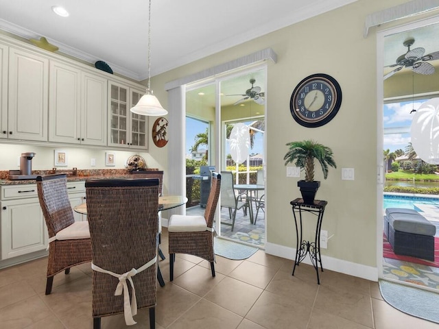2749 Lambay Ct, Cape Coral, FL 33991 - dining area featuring ceiling fan, plenty of natural light, light tile patterned floors, recessed lighting, and crown molding