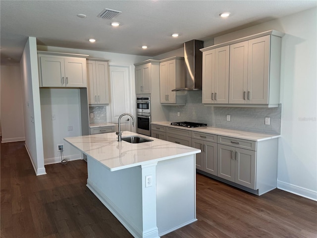 17134 Savory Mist Cir, Bradenton, FL 34211 - kitchen featuring wall chimney range hood, gas cooktop, dark wood finished floors, double oven, and light stone counters