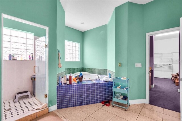 4105 37th St E, Bradenton, FL 34208 - bathroom featuring a stall shower, a jetted tub, tile patterned flooring, and a spacious closet