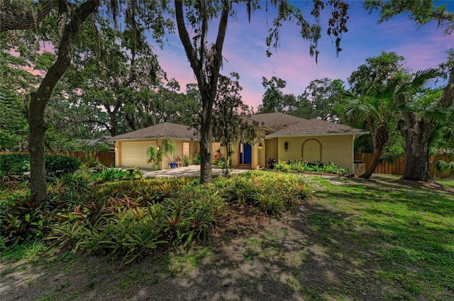 3217 Oak Grove Dr, Sarasota, FL 34243 - view of front of house featuring a garage and stucco siding