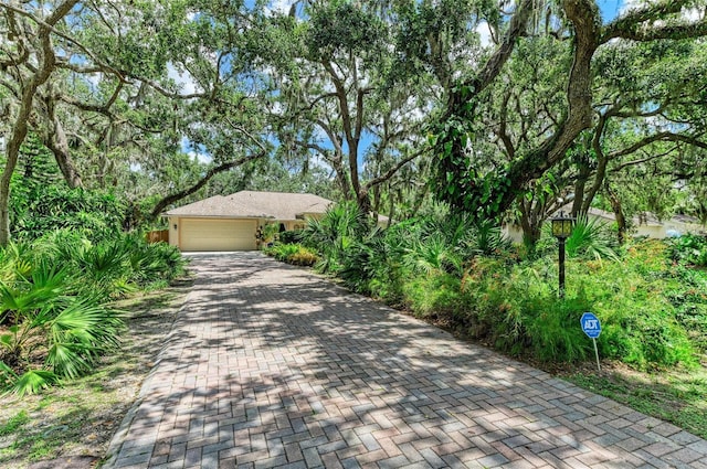 3217 Oak Grove Dr, Sarasota, FL 34243 - view of front facade featuring decorative driveway and an attached garage