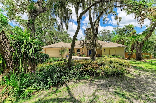 3217 Oak Grove Dr, Sarasota, FL 34243 - view of front facade with an attached garage and stucco siding