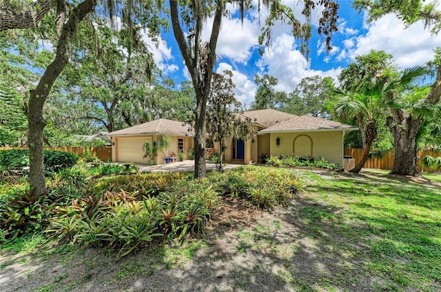 3217 Oak Grove Dr, Sarasota, FL 34243 - view of front of house featuring an attached garage and stucco siding