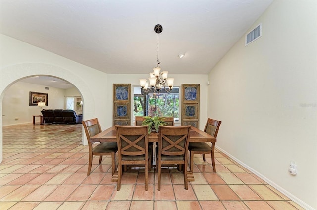 3217 Oak Grove Dr, Sarasota, FL 34243 - dining area featuring a chandelier and arched walkways
