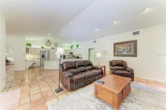3217 Oak Grove Dr, Sarasota, FL 34243 - living area featuring light tile patterned floors, vaulted ceiling, recessed lighting, and arched walkways