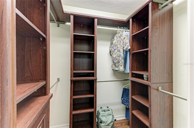 3217 Oak Grove Dr, Sarasota, FL 34243 - walk in closet featuring wood finished floors