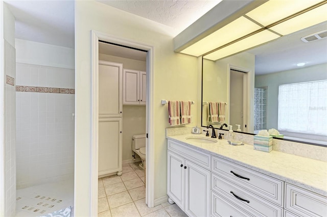 3217 Oak Grove Dr, Sarasota, FL 34243 - bathroom with tile patterned flooring, vanity, and tiled shower