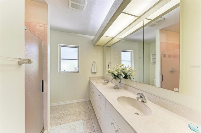 3217 Oak Grove Dr, Sarasota, FL 34243 - bathroom featuring healthy amount of natural light, double vanity, a stall shower, and tile patterned flooring