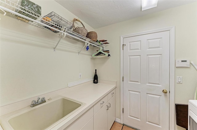 3217 Oak Grove Dr, Sarasota, FL 34243 - laundry area featuring light tile patterned floors and a sink