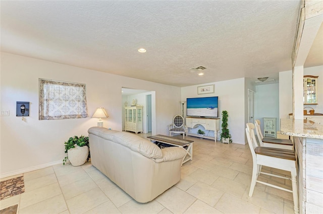 5415 13th Avenue Dr W, Bradenton, FL 34209 - living room featuring a textured ceiling, light tile patterned floors, and recessed lighting