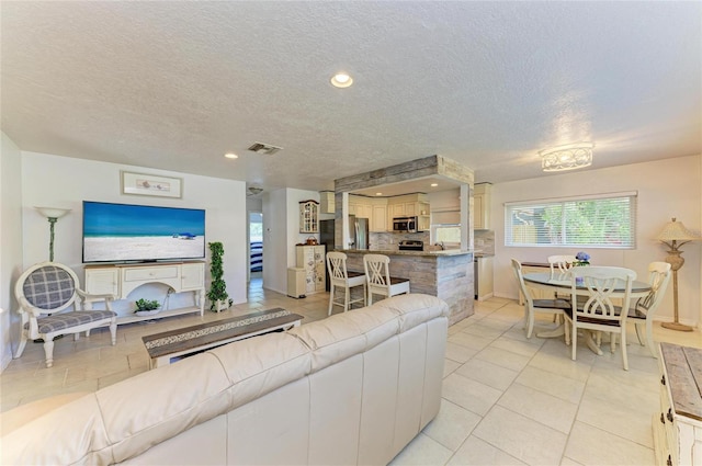 5415 13th Avenue Dr W, Bradenton, FL 34209 - living area with a textured ceiling, light tile patterned floors, and recessed lighting