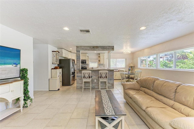 5415 13th Avenue Dr W, Bradenton, FL 34209 - living room featuring a textured ceiling, light tile patterned floors, and recessed lighting