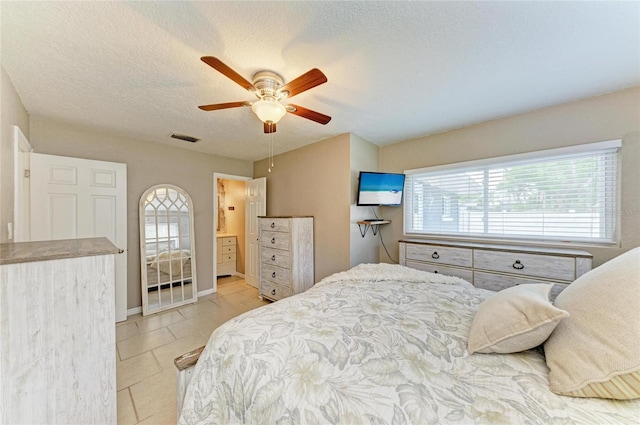 5415 13th Avenue Dr W, Bradenton, FL 34209 - bedroom with light tile patterned floors, a ceiling fan, and a textured ceiling