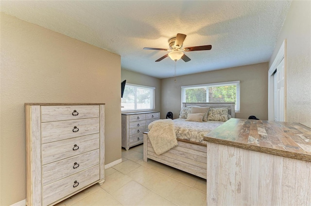 5415 13th Avenue Dr W, Bradenton, FL 34209 - bedroom featuring light tile patterned flooring, a textured ceiling, and ceiling fan