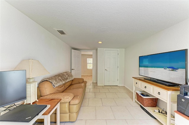 5415 13th Avenue Dr W, Bradenton, FL 34209 - living area with a textured ceiling and light tile patterned floors