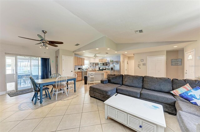 2406 15th St W, Palmetto, FL 34221 - living area with a ceiling fan, lofted ceiling, light tile patterned flooring, and recessed lighting