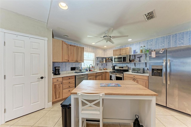 2406 15th St W, Palmetto, FL 34221 - kitchen with appliances with stainless steel finishes, ceiling fan, light tile patterned floors, butcher block counters, and recessed lighting