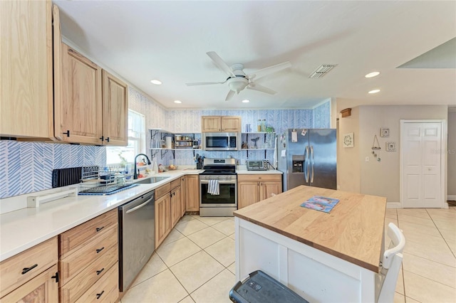 2406 15th St W, Palmetto, FL 34221 - kitchen featuring appliances with stainless steel finishes, light brown cabinets, light tile patterned flooring, and recessed lighting