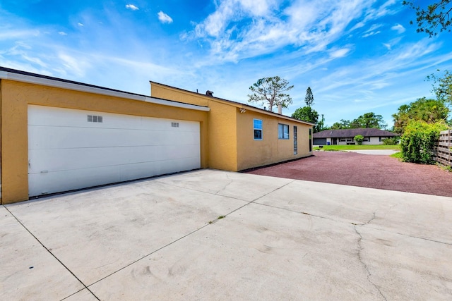 2315 Riverwood Pines Dr, Sarasota, FL 34231 - view of front of house featuring concrete driveway, stucco siding, and an attached garage