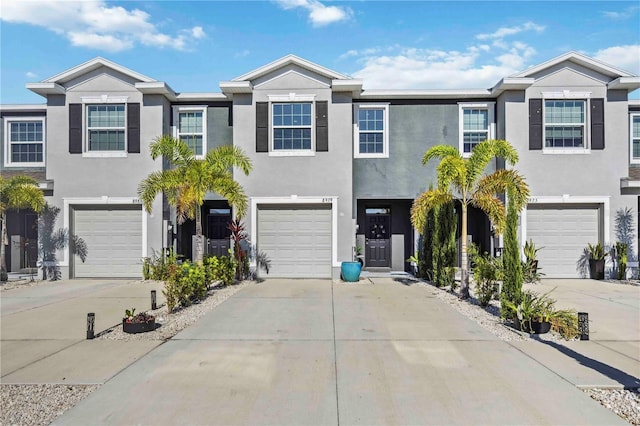 8979 Milestone Dr, Sarasota, FL 34238 - view of property featuring an attached garage, driveway, and stucco siding