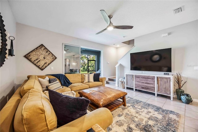 8979 Milestone Dr, Sarasota, FL 34238 - living room with light tile patterned floors, ceiling fan, and stairs
