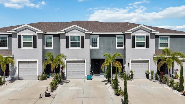 8979 Milestone Dr, Sarasota, FL 34238 - townhome / multi-family property with driveway, an attached garage, and stucco siding