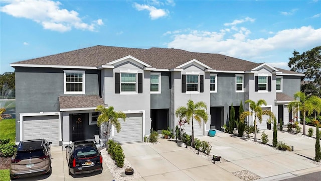 8979 Milestone Dr, Sarasota, FL 34238 - view of property featuring stucco siding, driveway, roof with shingles, and an attached garage