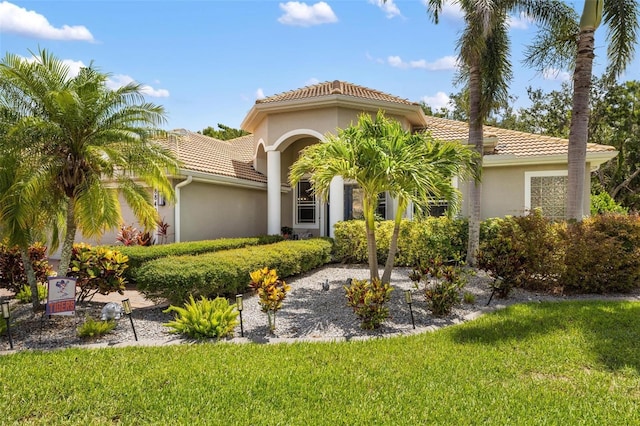 8840 Brookfield Ter, Bradenton, FL 34212 - mediterranean / spanish home featuring a tile roof, a front lawn, and stucco siding