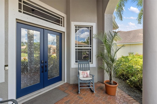 8840 Brookfield Ter, Bradenton, FL 34212 - view of exterior entry with french doors and stucco siding