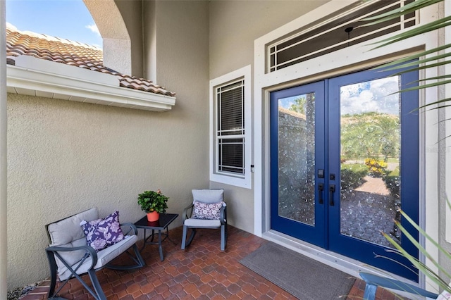 8840 Brookfield Ter, Bradenton, FL 34212 - doorway to property featuring french doors, stucco siding, and a tile roof
