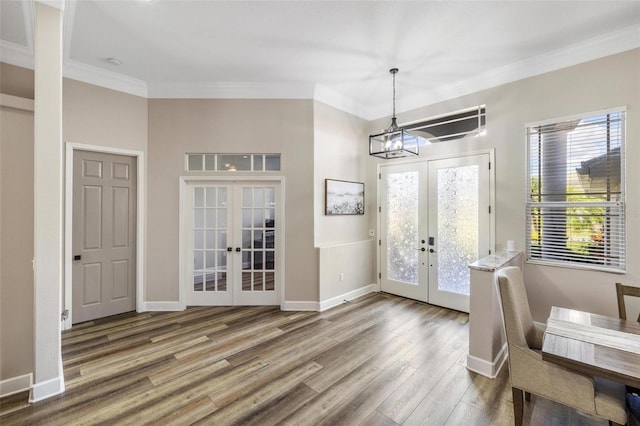 8840 Brookfield Ter, Bradenton, FL 34212 - foyer with french doors, wood finished floors, ornamental molding, and a chandelier