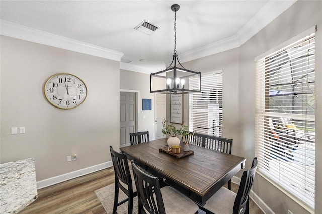 8840 Brookfield Ter, Bradenton, FL 34212 - dining space featuring a chandelier, ornamental molding, and wood finished floors