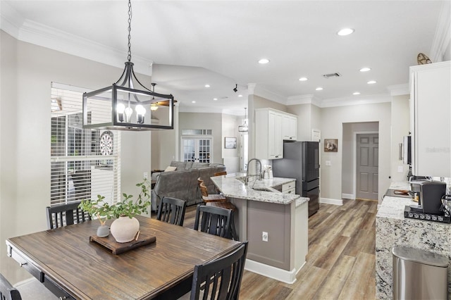 8840 Brookfield Ter, Bradenton, FL 34212 - dining space with crown molding, light wood-style flooring, and recessed lighting