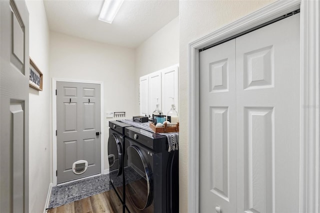 8840 Brookfield Ter, Bradenton, FL 34212 - washroom featuring washer and clothes dryer, dark wood-style floors, and cabinet space