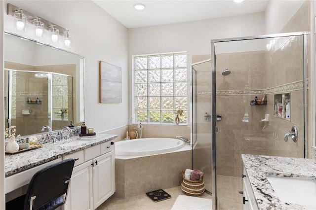 8840 Brookfield Ter, Bradenton, FL 34212 - bathroom with two vanities, a shower stall, a garden tub, and tile patterned flooring
