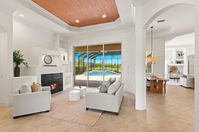 7144 Ashland Gln, Lakewood Ranch, FL 34202 - living area with a raised ceiling, built in features, light tile patterned floors, wood ceiling, and crown molding