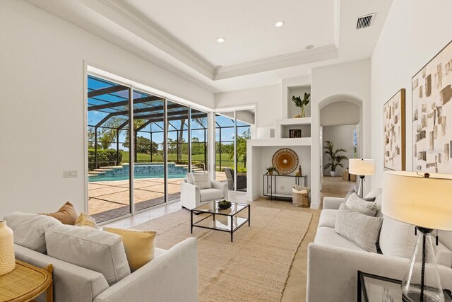 7144 Ashland Gln, Lakewood Ranch, FL 34202 - living area featuring a sunroom, light tile patterned flooring, built in shelves, recessed lighting, and a tray ceiling