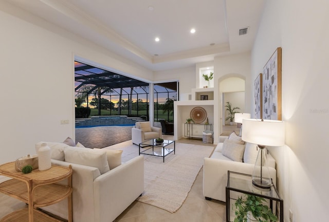 7144 Ashland Gln, Lakewood Ranch, FL 34202 - living room featuring a sunroom, a raised ceiling, recessed lighting, and light tile patterned floors
