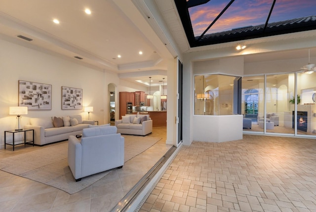 7144 Ashland Gln, Lakewood Ranch, FL 34202 - living room with arched walkways, recessed lighting, and a tray ceiling