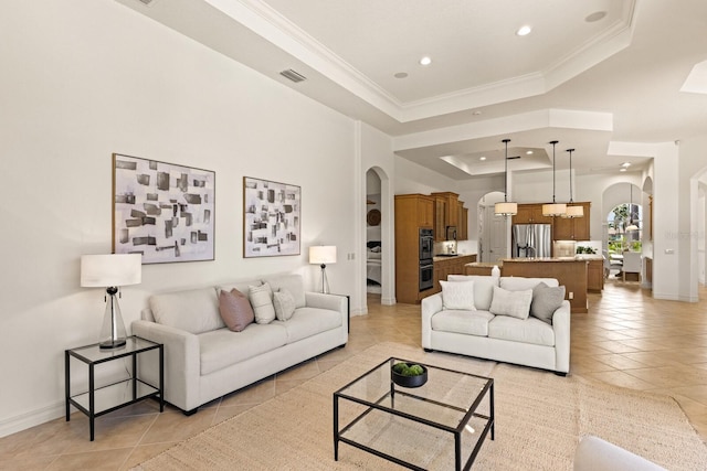 7144 Ashland Gln, Lakewood Ranch, FL 34202 - living area featuring arched walkways, light tile patterned floors, a tray ceiling, recessed lighting, and ornamental molding