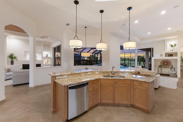 7144 Ashland Gln, Lakewood Ranch, FL 34202 - kitchen with dishwasher, open floor plan, light stone counters, decorative light fixtures, and recessed lighting