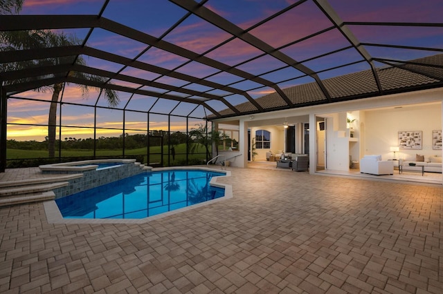 7144 Ashland Gln, Lakewood Ranch, FL 34202 - pool at dusk with a patio, a pool with connected hot tub, an outdoor hangout area, and a lanai