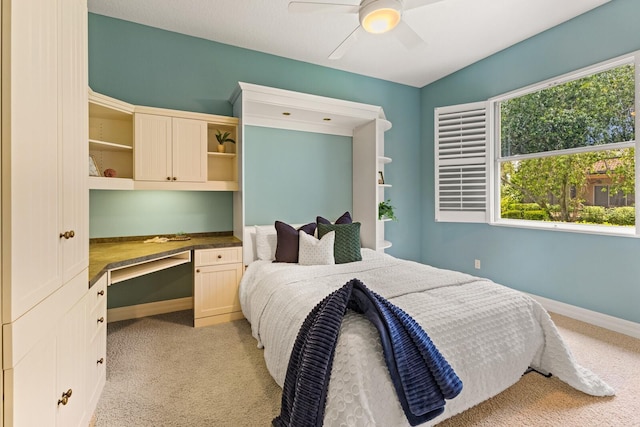7144 Ashland Gln, Lakewood Ranch, FL 34202 - bedroom featuring built in desk, light colored carpet, and a ceiling fan