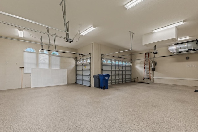 7144 Ashland Gln, Lakewood Ranch, FL 34202 - garage with a garage door opener and a central vacuum unit