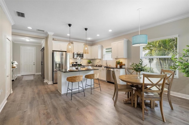 12261 Stuart Dr, Venice, FL 34293 - dining room featuring light wood-style floors, recessed lighting, and crown molding