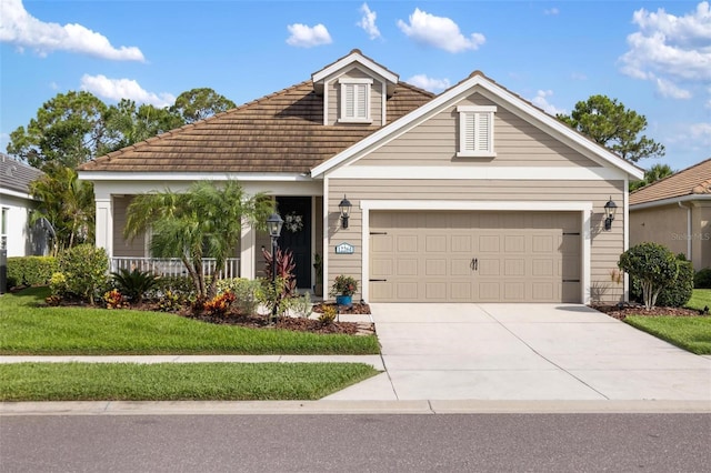 12261 Stuart Dr, Venice, FL 34293 - view of front of house with a garage, driveway, a front yard, and a tiled roof