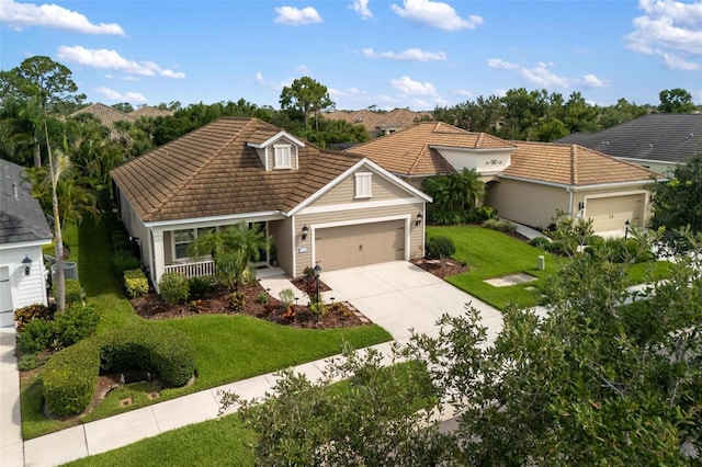 12261 Stuart Dr, Venice, FL 34293 - view of front of property with a tiled roof, a garage, concrete driveway, and a front yard
