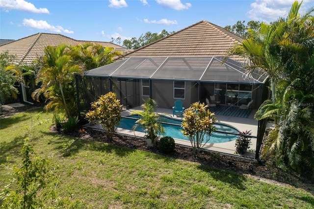 12261 Stuart Dr, Venice, FL 34293 - back of house featuring a tiled roof, glass enclosure, and a patio area